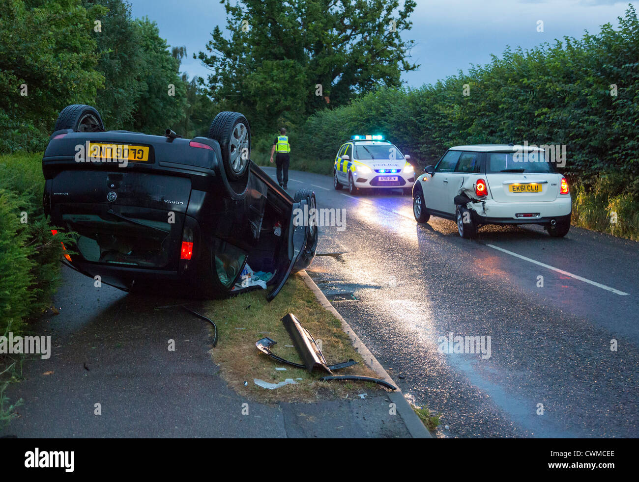 car accident where a car overturned at the side of the road Stock Photo