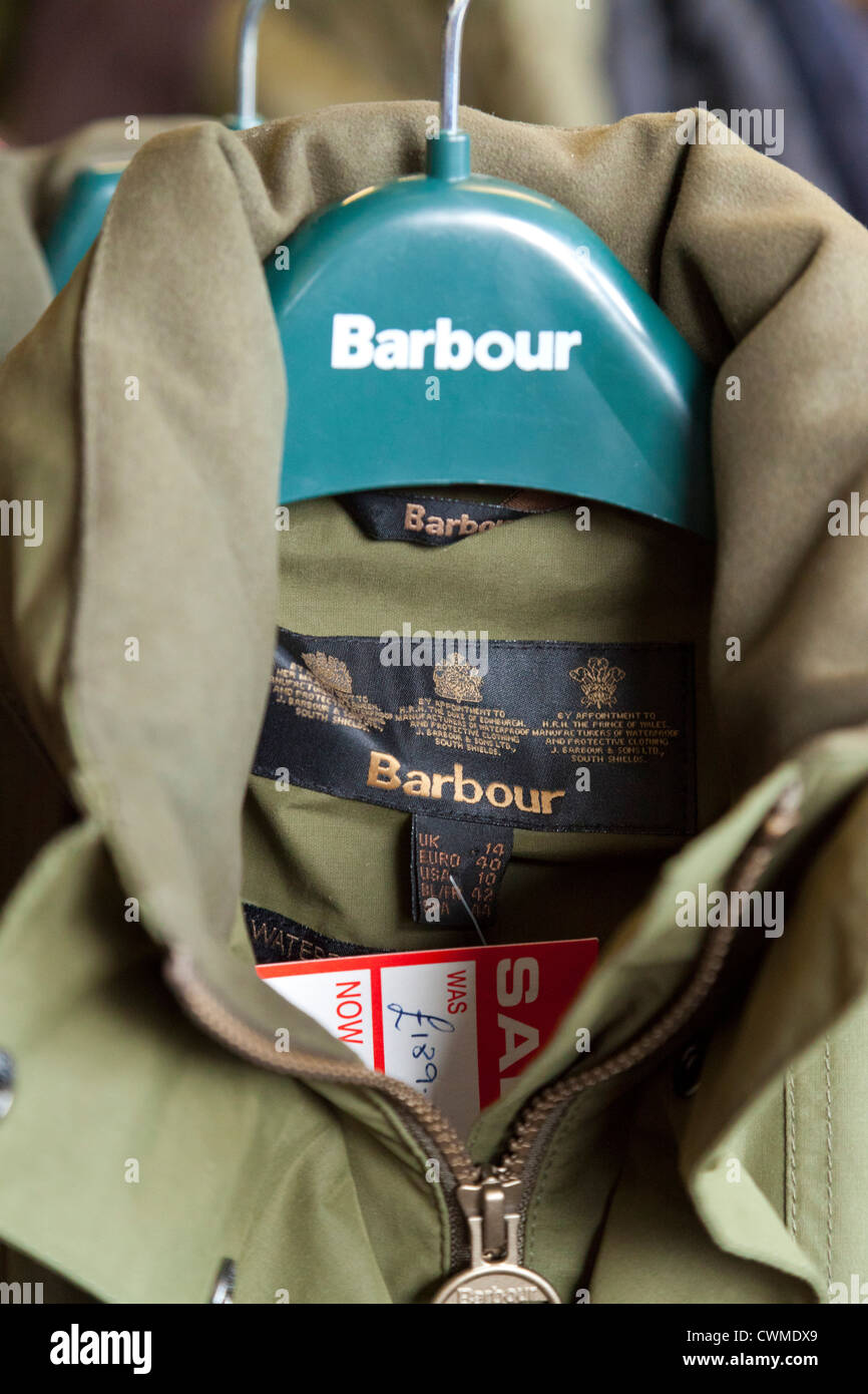 Barbour logo on clothes hanger with jacket Stock Photo - Alamy