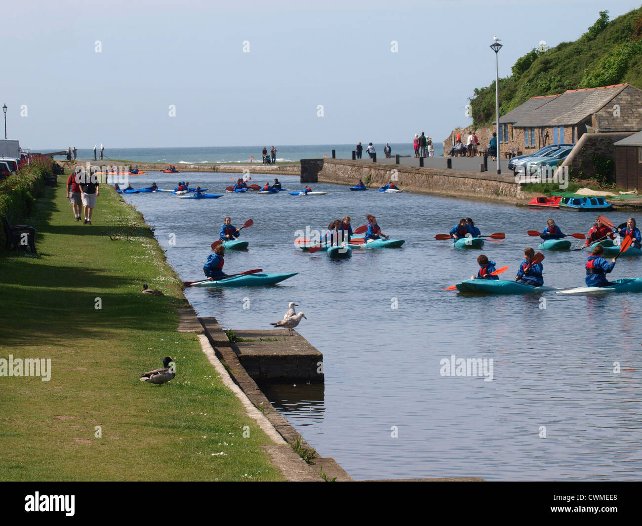 Children learning to kayak on the Bude Canal, Cornwall, UK Stock Photo