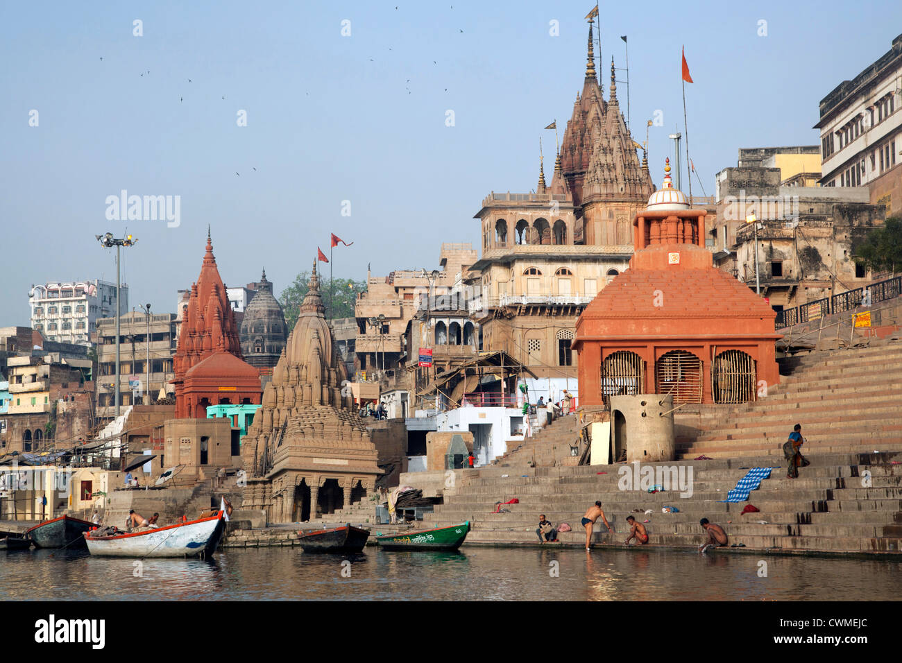 Indian men washing at a ghat along the holy Ganges river, Varanasi, Uttar Pradesh, India Stock Photo