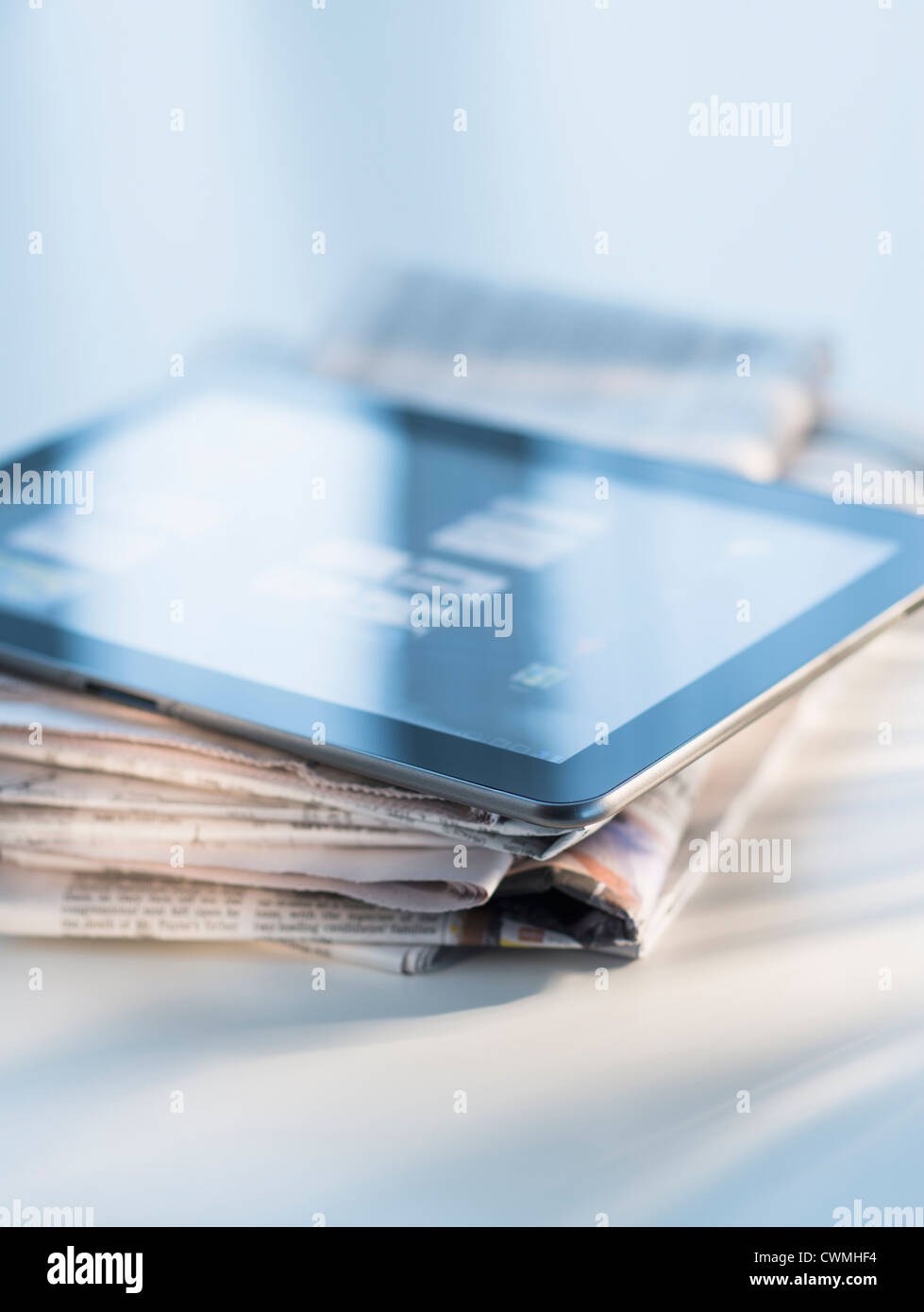 Studio shot of newspaper and tablet PC Stock Photo