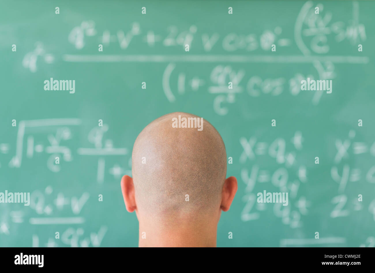Man in front of blackboard with formulas Stock Photo