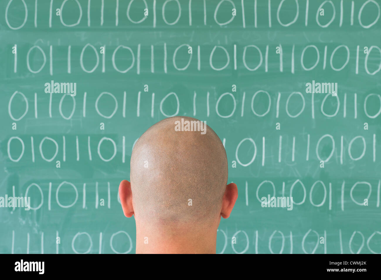Man in front of blackboard with binary code Stock Photo