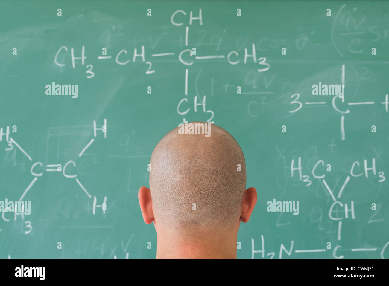 Man in front of blackboard with formulas Stock Photo