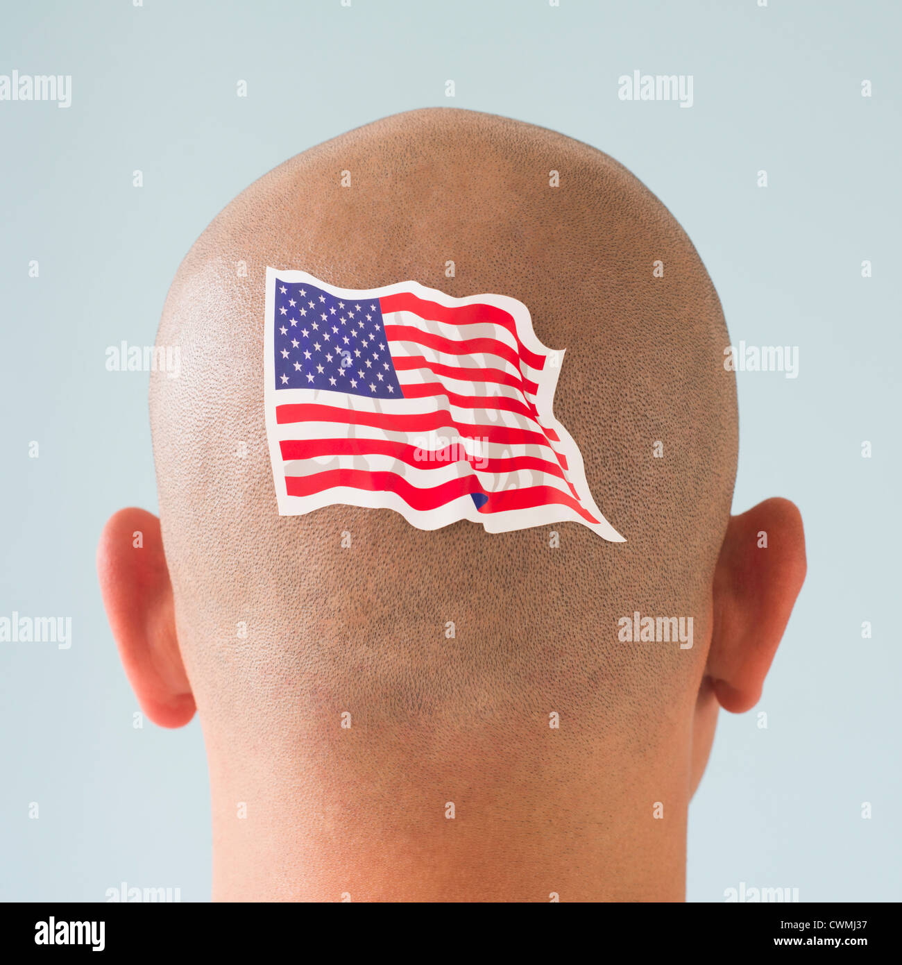 Back view of man with American flag tattoo on head Stock Photo