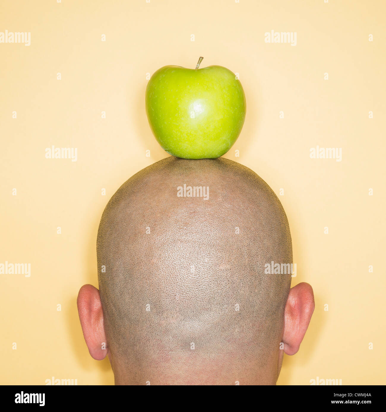 Back view of man with apple on head Stock Photo