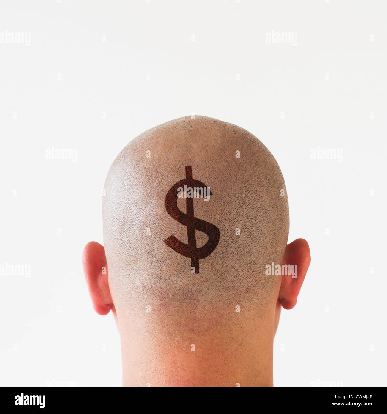Back view of man with dollar sign on shaved head Stock Photo