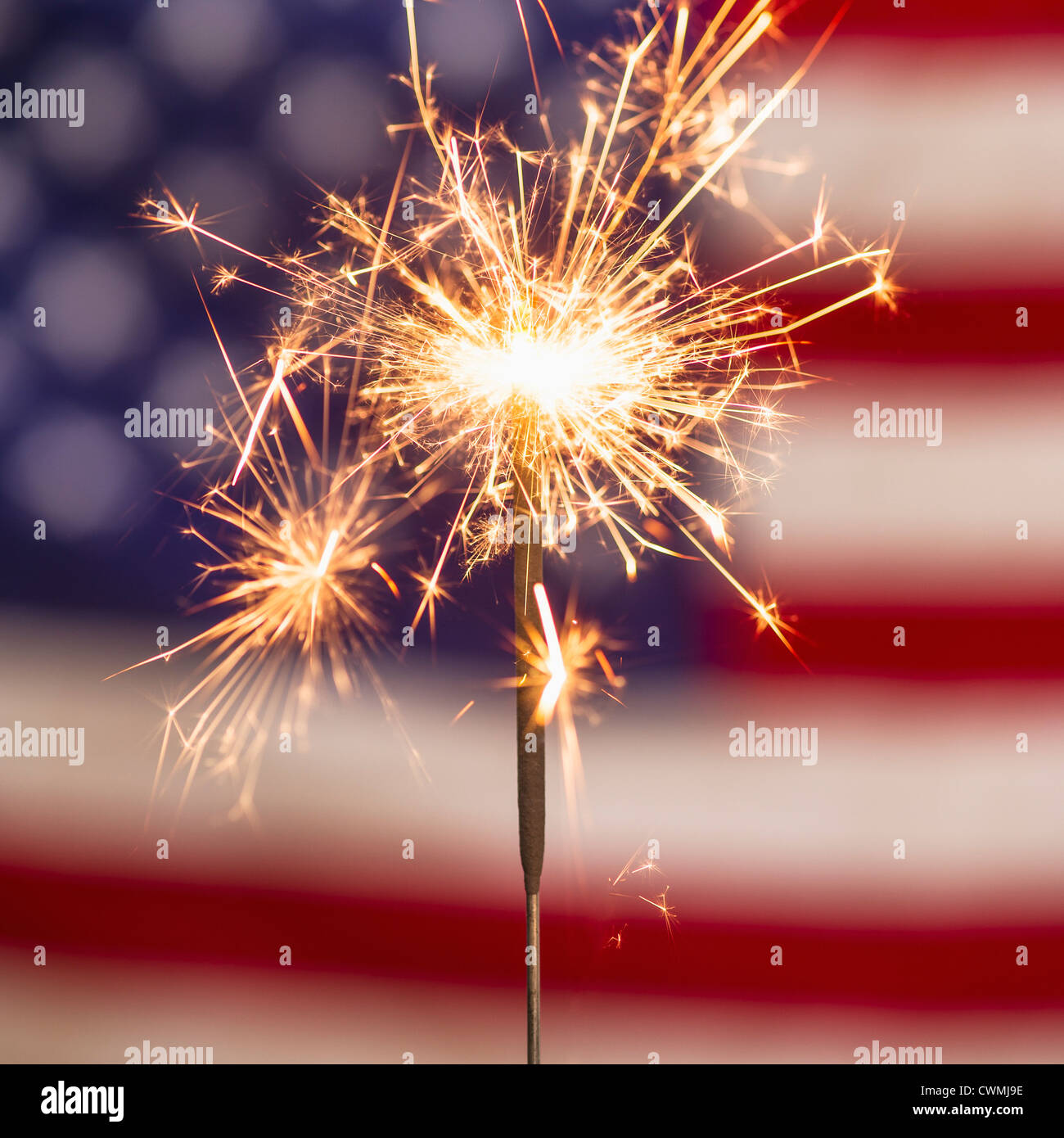 Sparkler and American flag Stock Photo