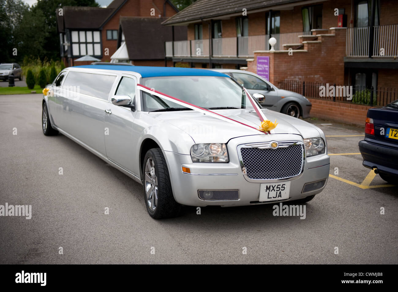 a silver stretch limousine wedding car made by Chrysler Stock Photo