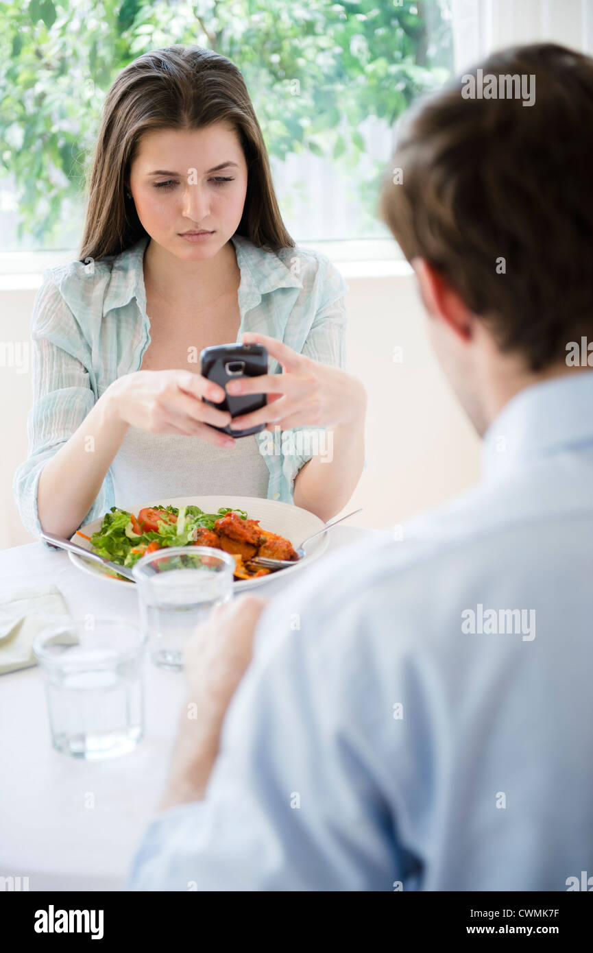 USA, New Jersey, Jersey City, Yung woman texting over meal Stock Photo