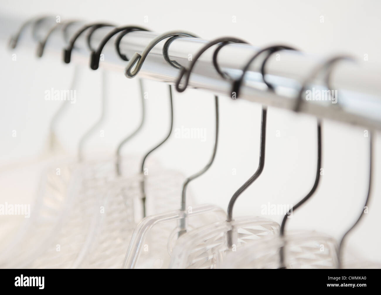 Coat hangers on clothes rack Stock Photo