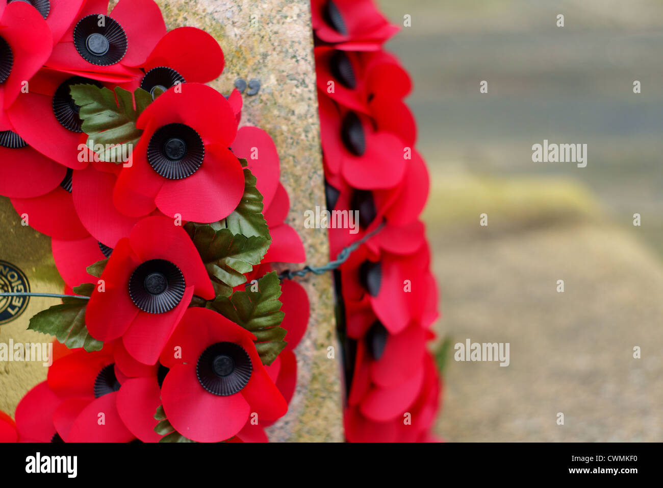 Remembrance day poppy wreathes on a war memorial to commemorate fallen ...