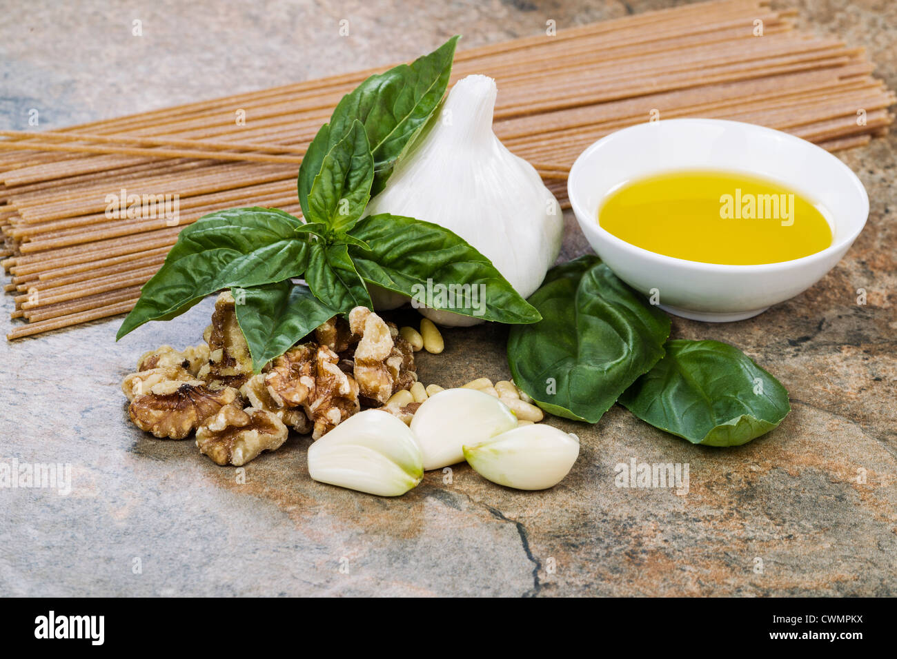 Fresh basil, garlic, olive oil, pine and walnuts and whole wheat pasta Stock Photo