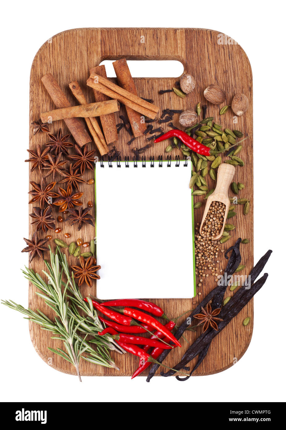 Open notebook with spices and herbs on the old wooden cutting board. Isolated on white. Stock Photo