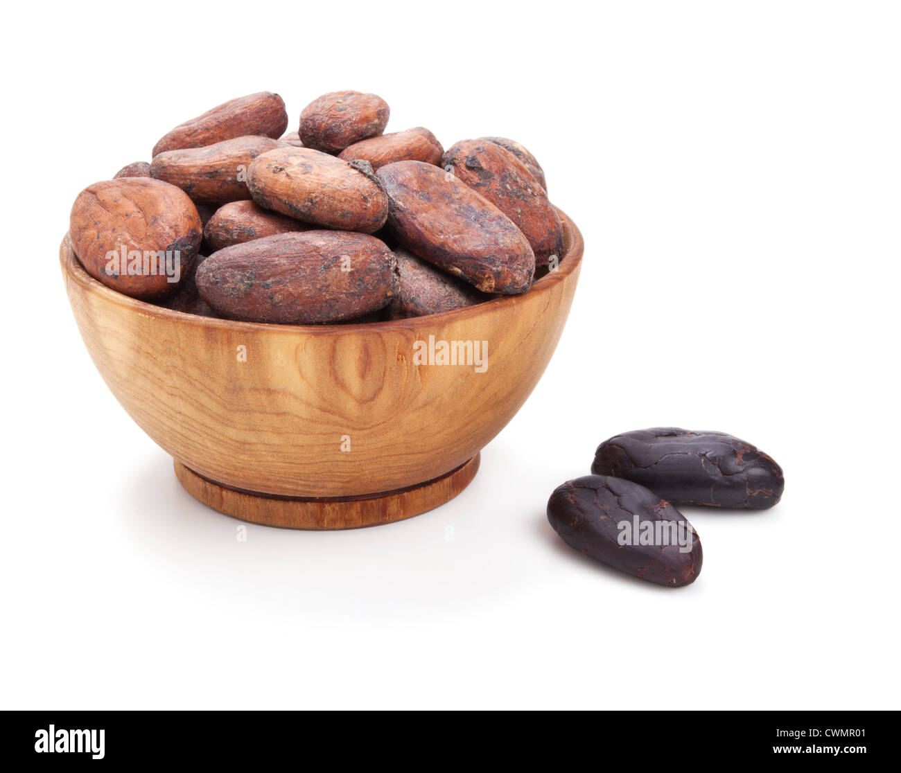 wooden bowl full of cacao beans isolated on white background Stock Photo