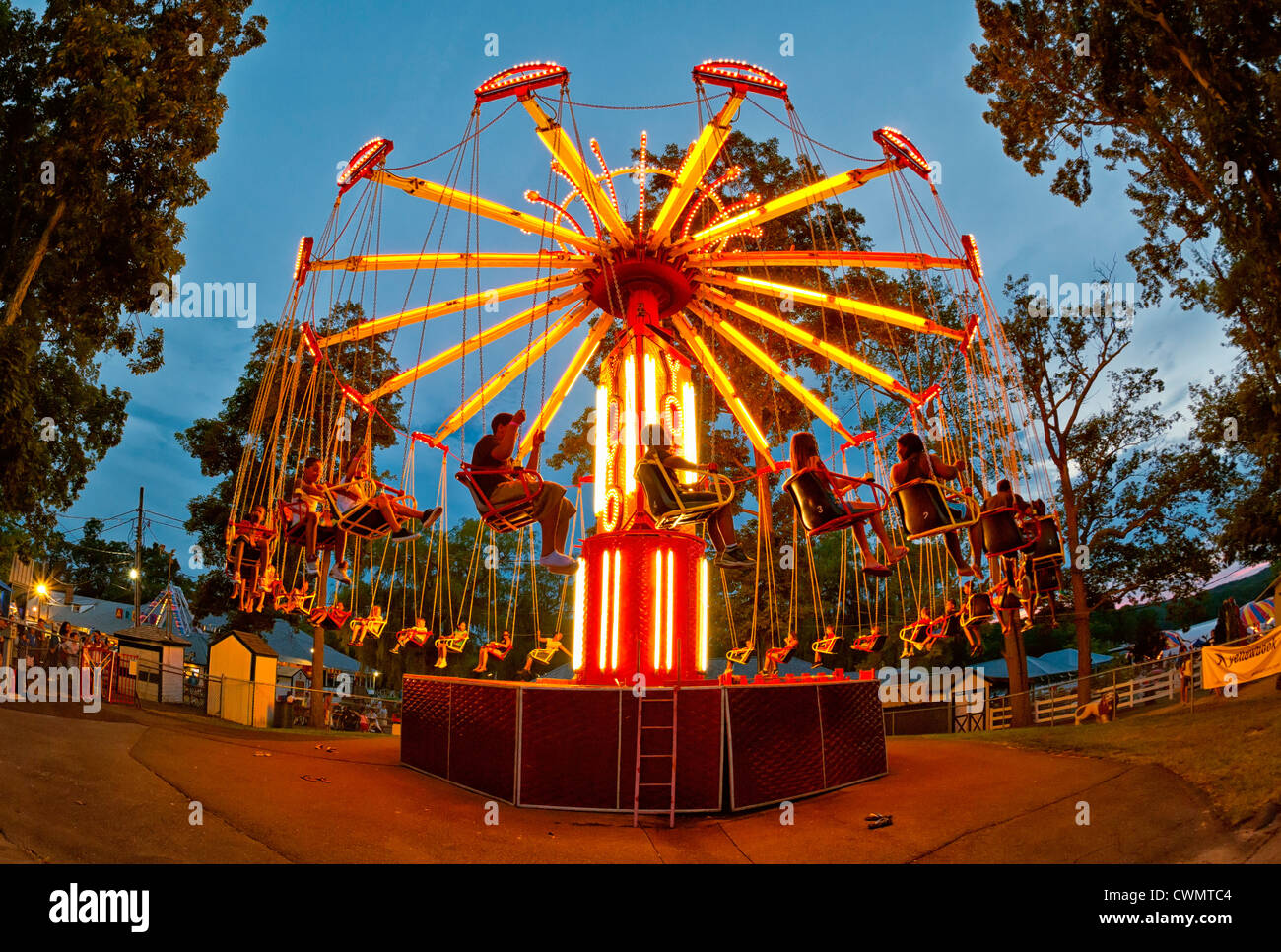 Aug. 25, 2012 - Middlebury, Connecticut, U.S.- People spinning on colorfully lit Swing ride at night, at Quassy Amusement Park. Stock Photo