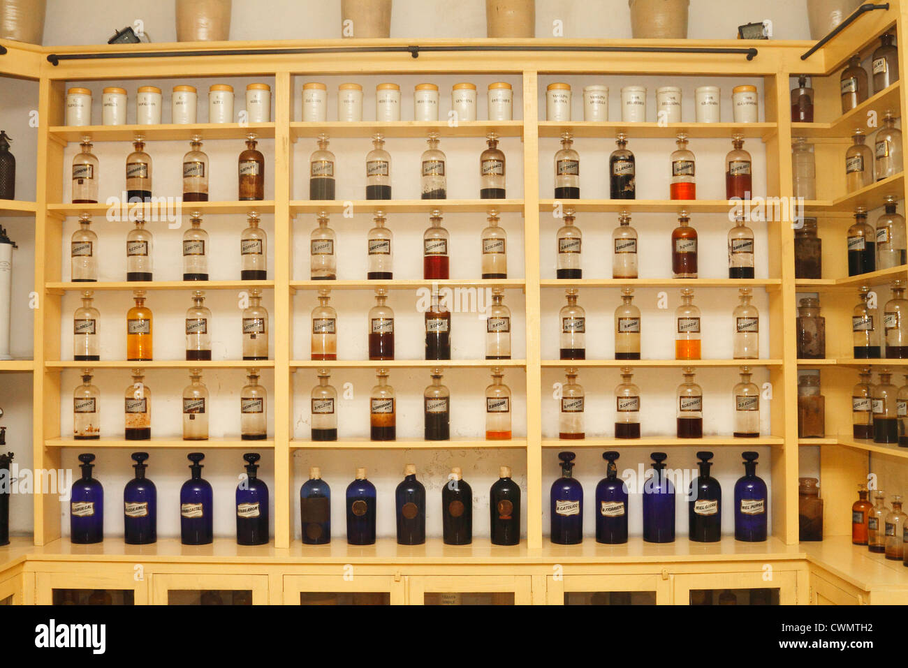 Vintage medical pharmaceutical colorful chemical bottles on the shelf