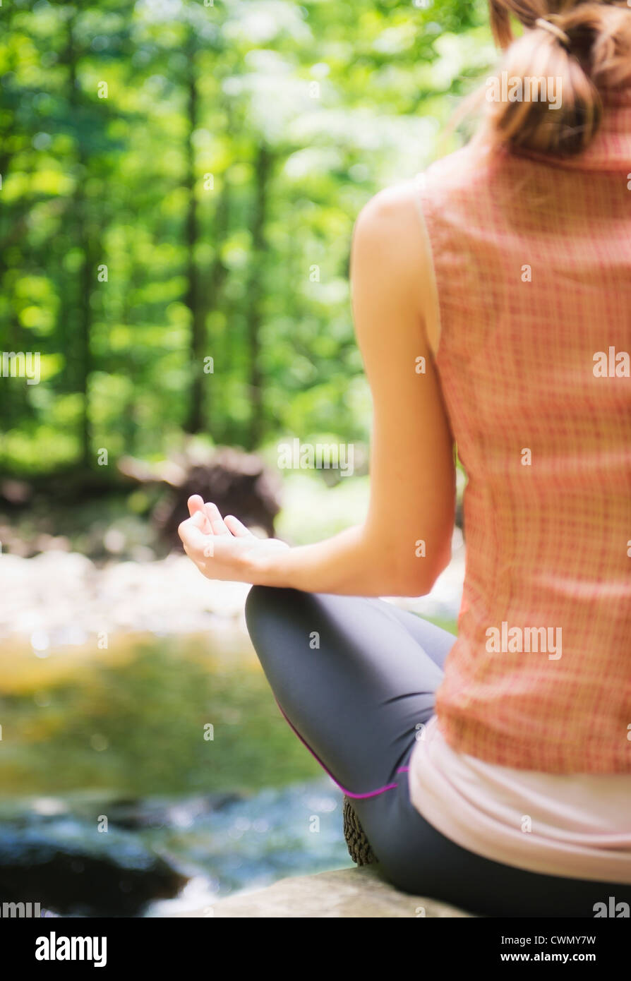 USA, New Jersey, Mendham, Woman practicing joga in forest Stock Photo