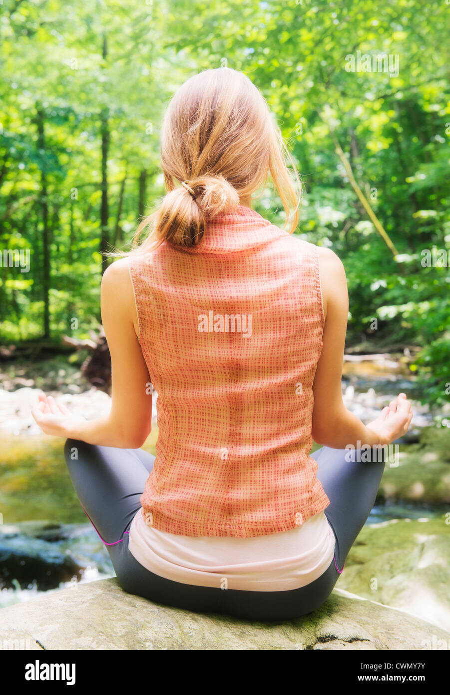 USA, New Jersey, Mendham, Woman practicing joga in forest Stock Photo