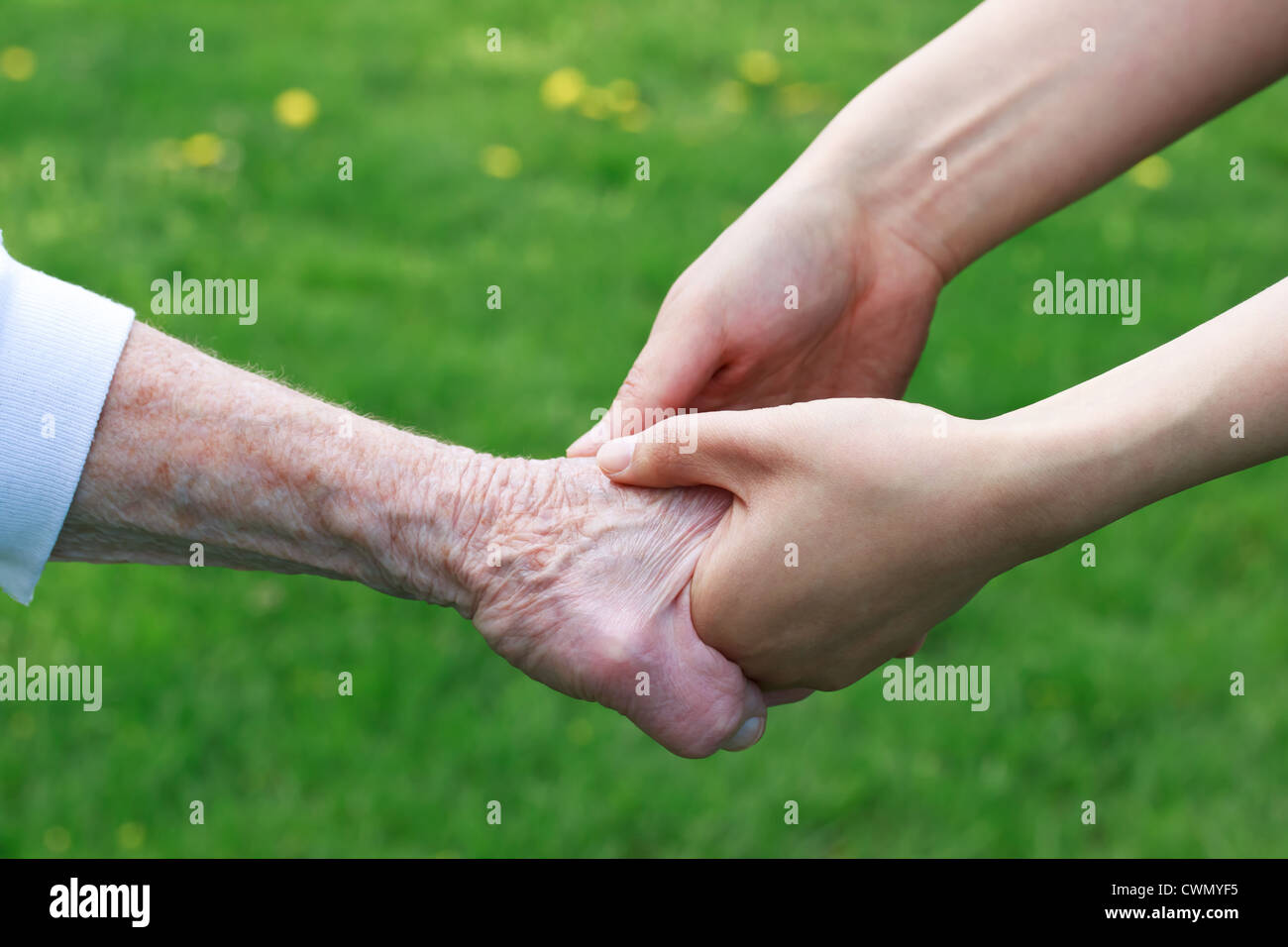 Senior and Young Women Holding Hands Outside Stock Photo - Alamy