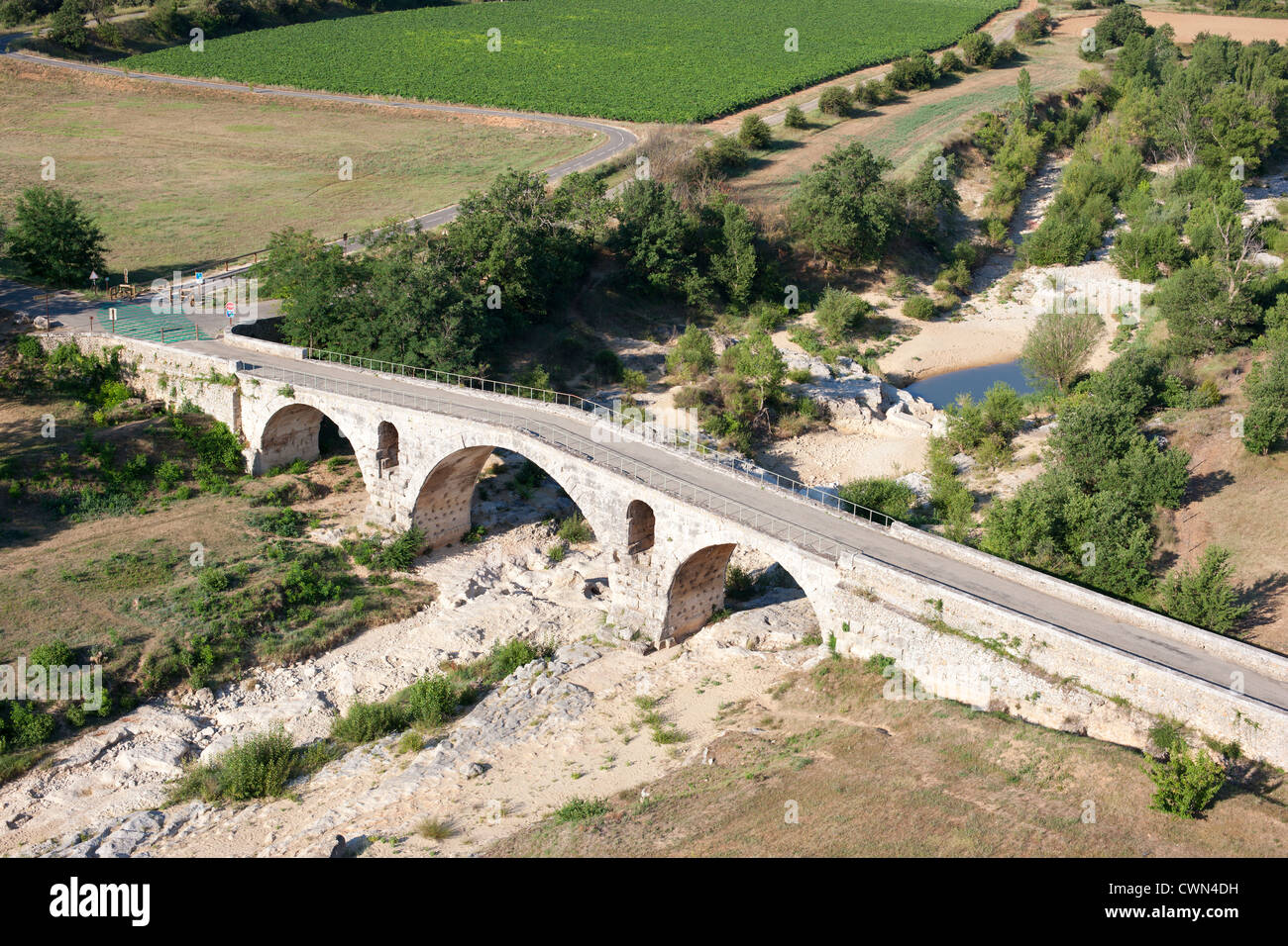 AERIAL VIEW. Pont Julien is a 2000-year-old stone arch Roman bridge on the Via Domitia. Apt, Provence, France. Stock Photo