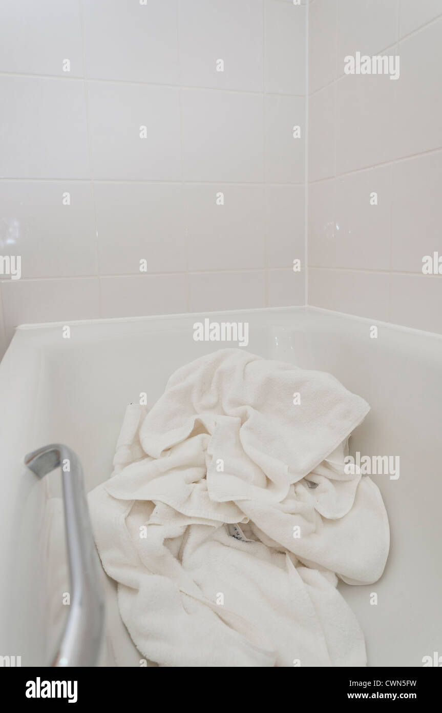 Towels left in hotel room bath for room service to refresh Stock Photo