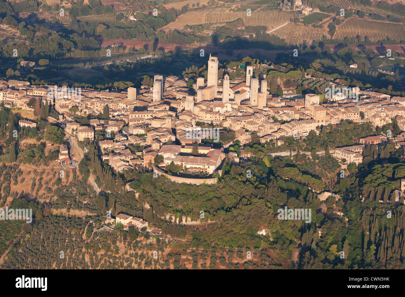 AERIAL VIEW. Medieval hilltop town with its many towers built by rich families centuries ago. San Gimignano, Province of Siena, Tuscany, Italy. Stock Photo