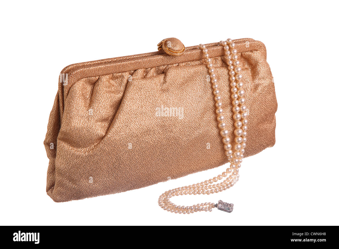 A vintage gold lame evening purse with a triple strand of pearls. Stock Photo