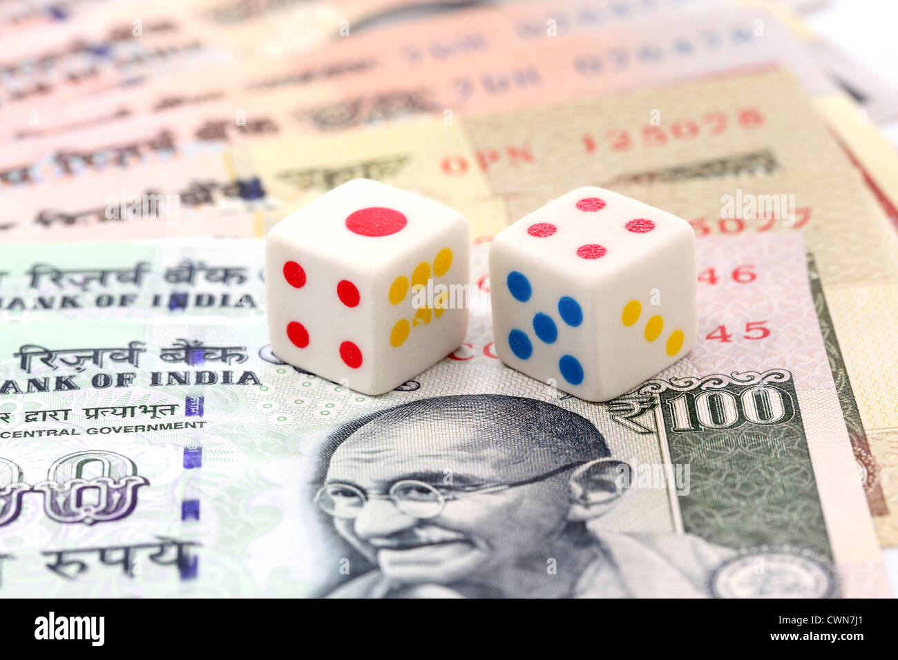 Indian currency notes and dice on white Stock Photo - Alamy