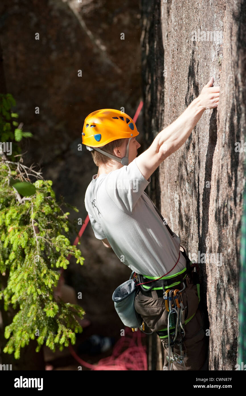 Climber climbing a rock wall Stock Photo Alamy