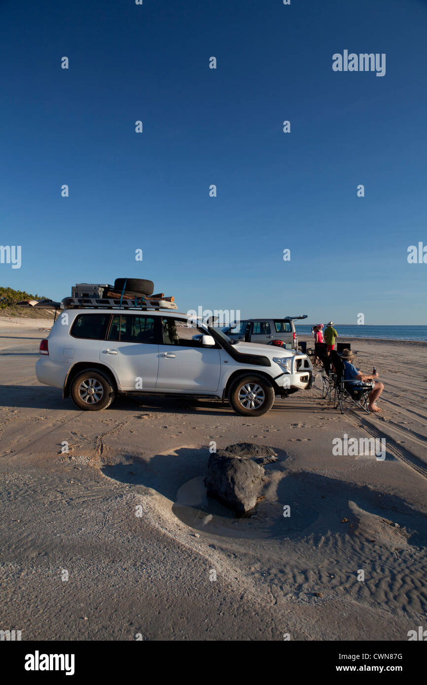 People sat watching the incoming sunset on Cable Beach, Broome, Western Australia Stock Photo