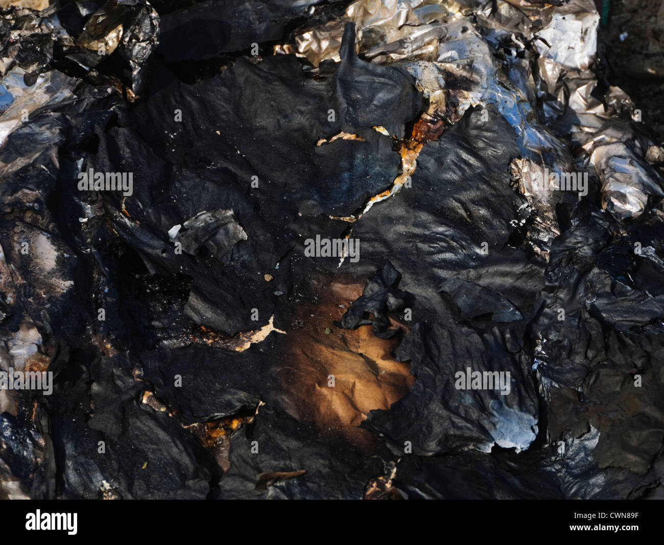 Totally burnt paper in a garbage dumping site Stock Photo - Alamy