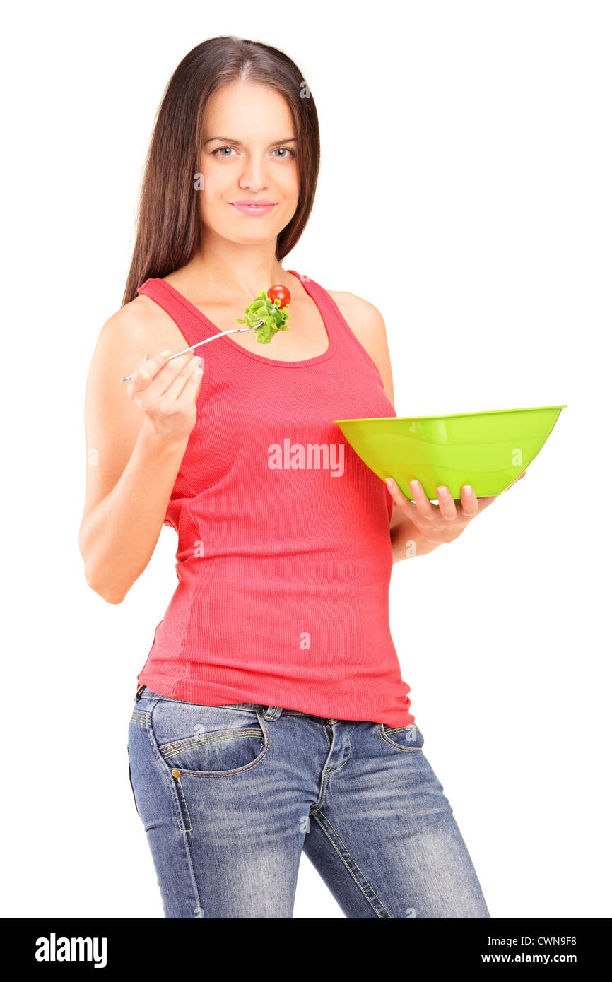 A young female eating a salad isolated against white background Stock Photo