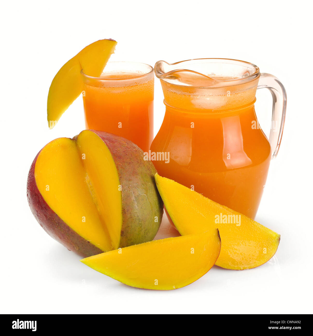 mango juice in a jug and a glass of fruit Stock Photo Alamy