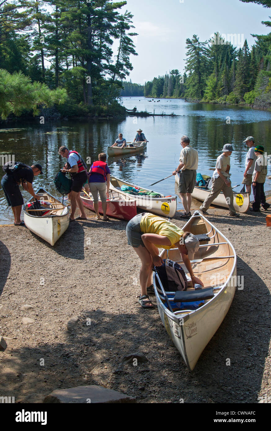 Canoe trippers crowd a landing on Canoe Lake as they prepare to portage their canoes in