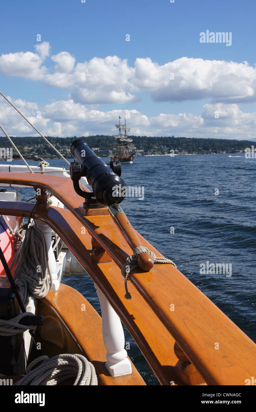 Swivel gun on deck with tallship sailing in background near Kirkland, Washington Stock Photo