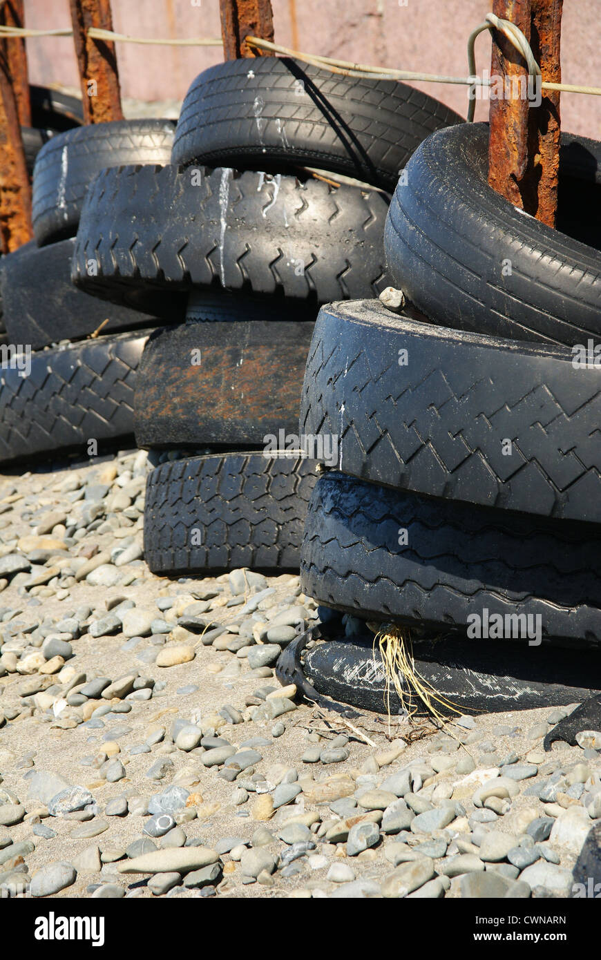 Old tyres used as a make shift coastal defense on Clifton beach in New Zealand Stock Photo