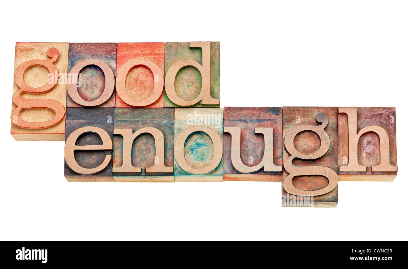 good enough - attitude or software design principle - isolated words in vintage letterpress wood type stained by color inks Stock Photo