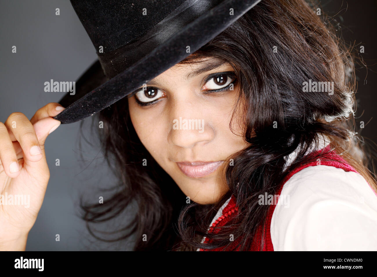Closeup view of young teen girl with black hat Stock Photo - Alamy