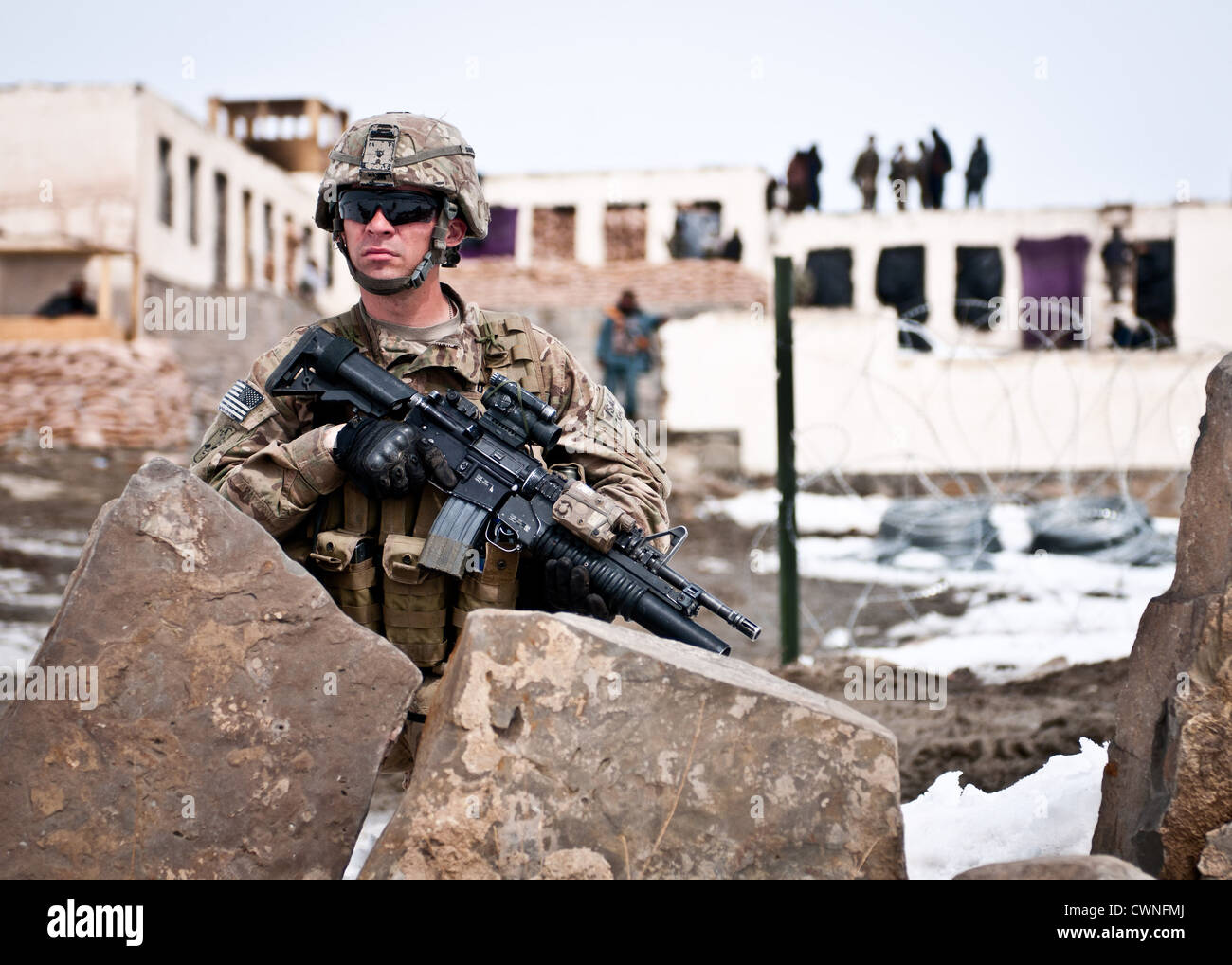 A US soldier keeps watch outside an Afghan Local Police checkpoint in Marzak village March 15, 2012 in Afghanistan. Stock Photo