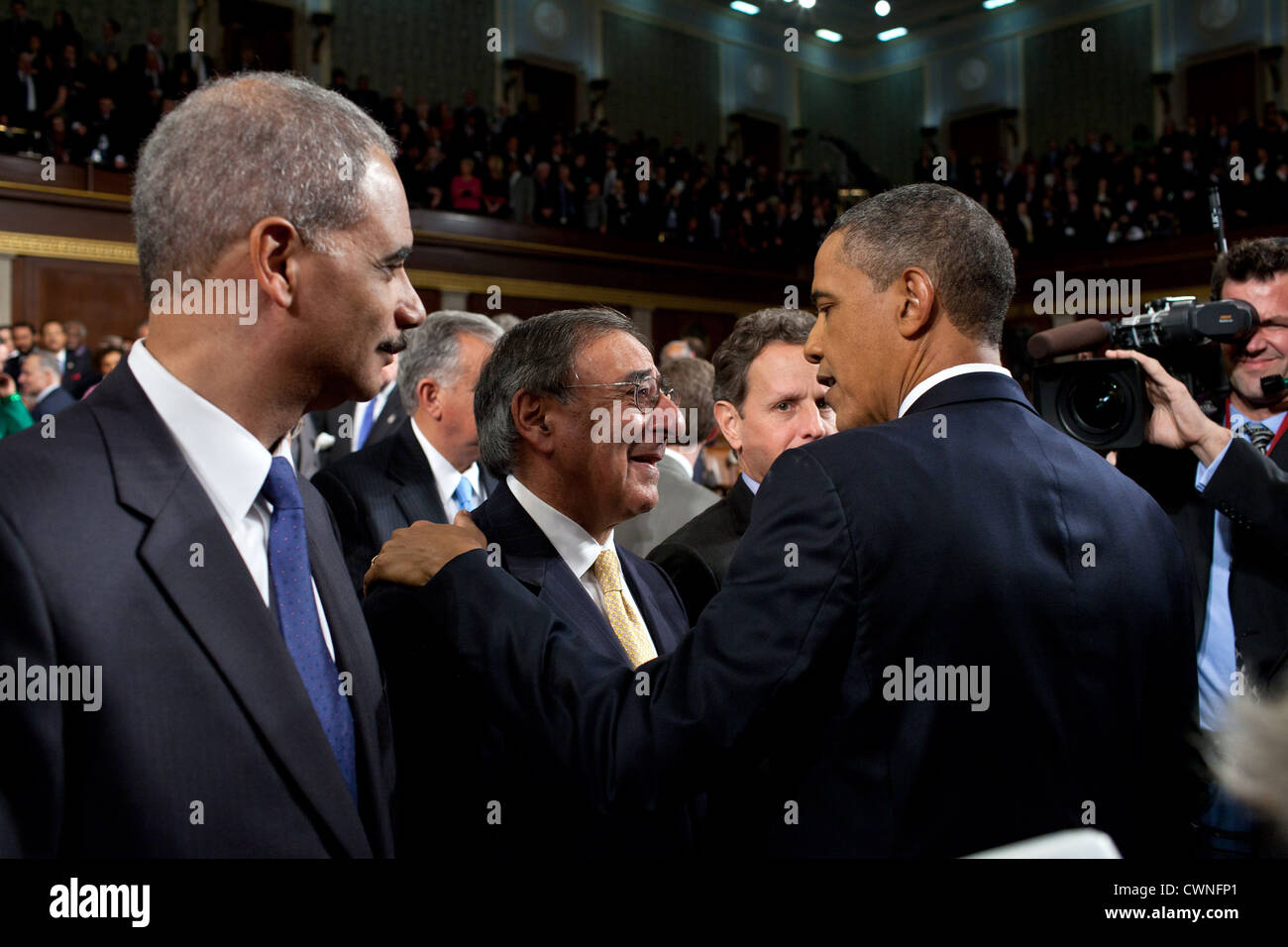 President Barack Obama greets Defense Secretary Leon Panetta after delivering the State of the Union address in the House Chamber at the U.S. Capitol Jan 24, 2012 in Washington, D.C., Jan. 24, 2012. Attorney General Eric Holder is seen at left. Stock Photo