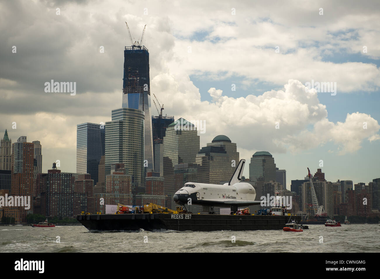 The space shuttle Enterprise is towed by barge up the Hudson River in New York with the World Trade Center's Freedom Tower in the background June 6, 2012 while on it's way to the Intrepid Sea, Air and Space Museum. Stock Photo
