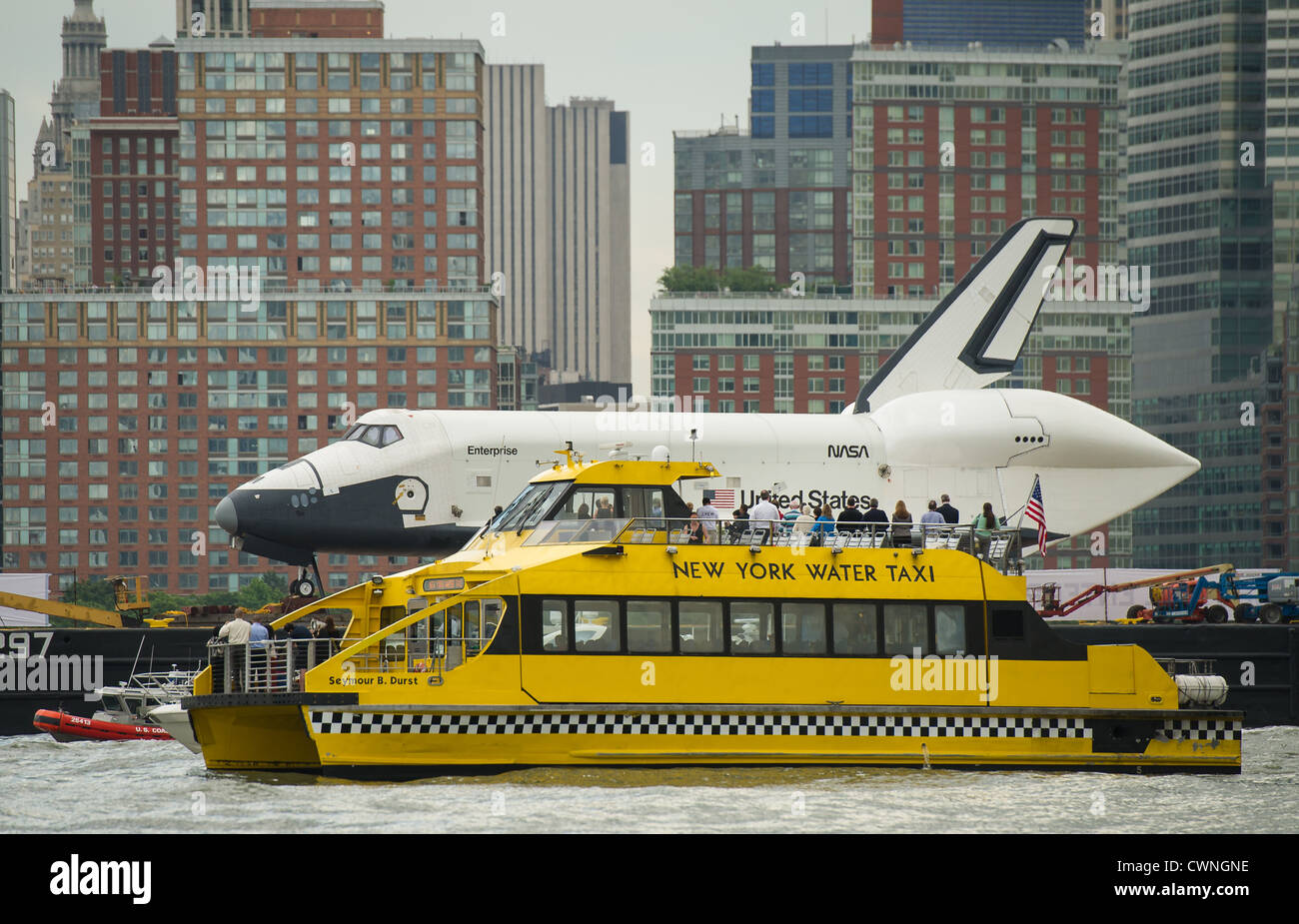 New York Water Taxi gets a close-up view of the space shuttle Enterprise as it is towed by barge up the Hudson River June 6, 2012 on it's way to the Intrepid Air and Space Museum where it will be permanently displayed, Stock Photo