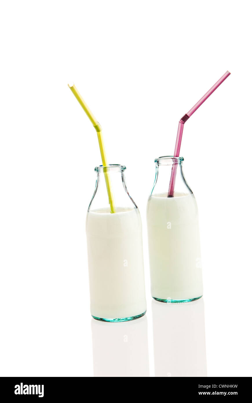 Milk in bottles with straws, isolated on 100% white background Stock Photo