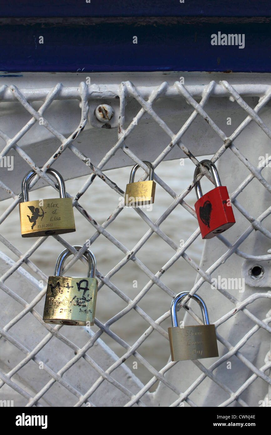 Locked padlocks on Tower Bridge above the River Thames, London England UK. Stock Photo