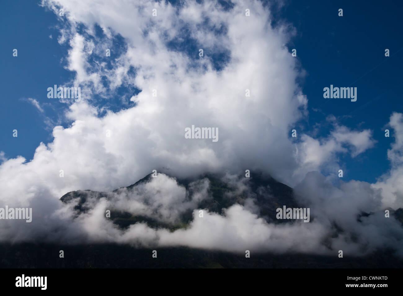 Clouds over Mountains in the Swiss Alps Stock Photo