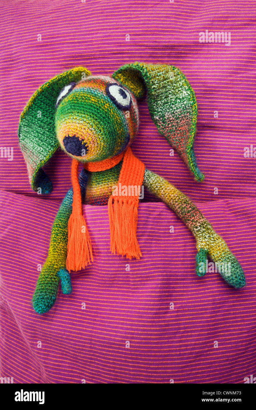 Stuffed animal, crochet-bunny, lying in bed Stock Photo