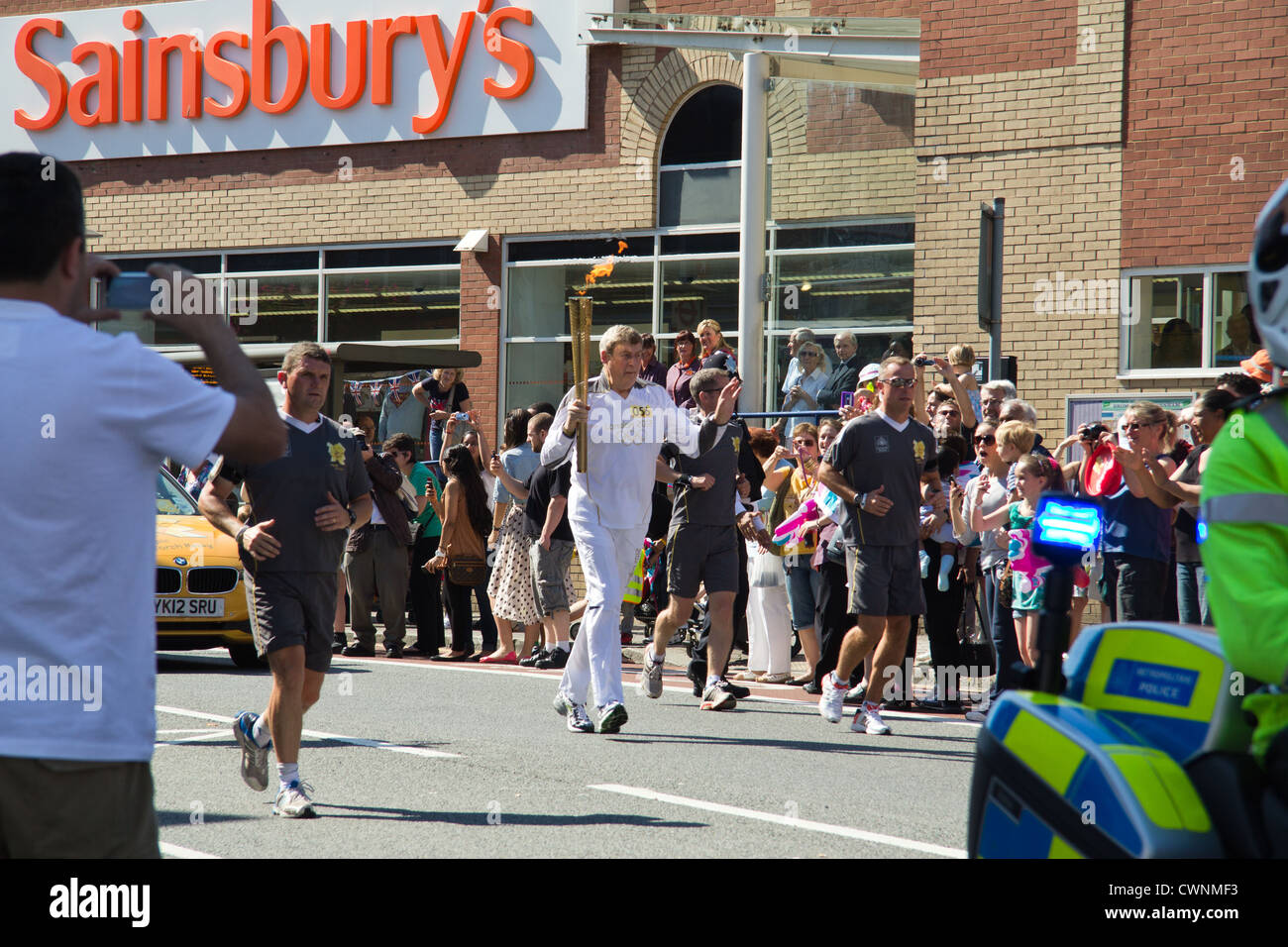 Large crowds gathering to welcome the Olympic flame at Penge High Street (South London) Stock Photo