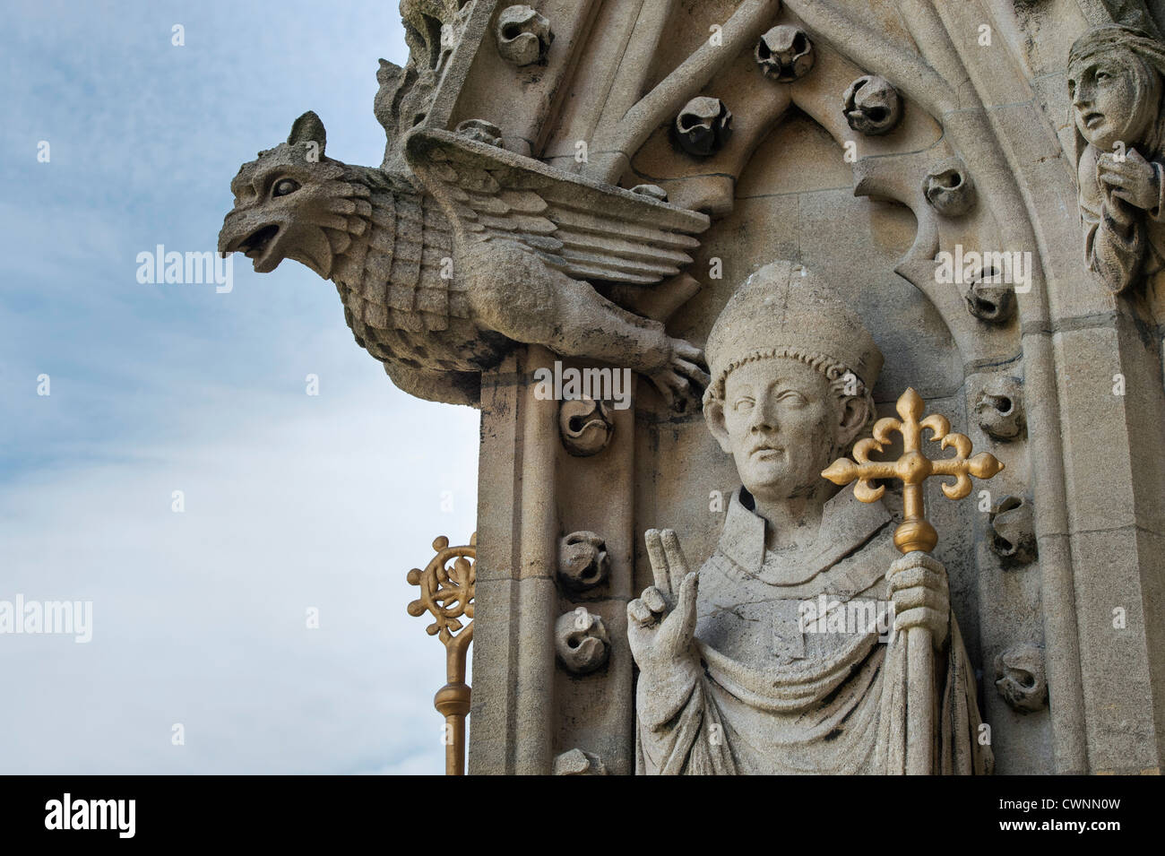 Carved stone gargoyle and Christian bishop figure on the tower of the University Church of St Mary the Virgin, Oxford, England Stock Photo