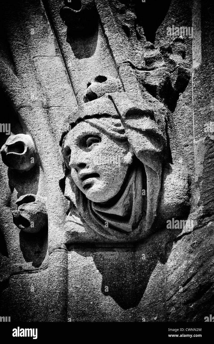 Carved stone womans head on the tower of the University Church of St Mary the Virgin, Oxford, England. Monochrome Stock Photo
